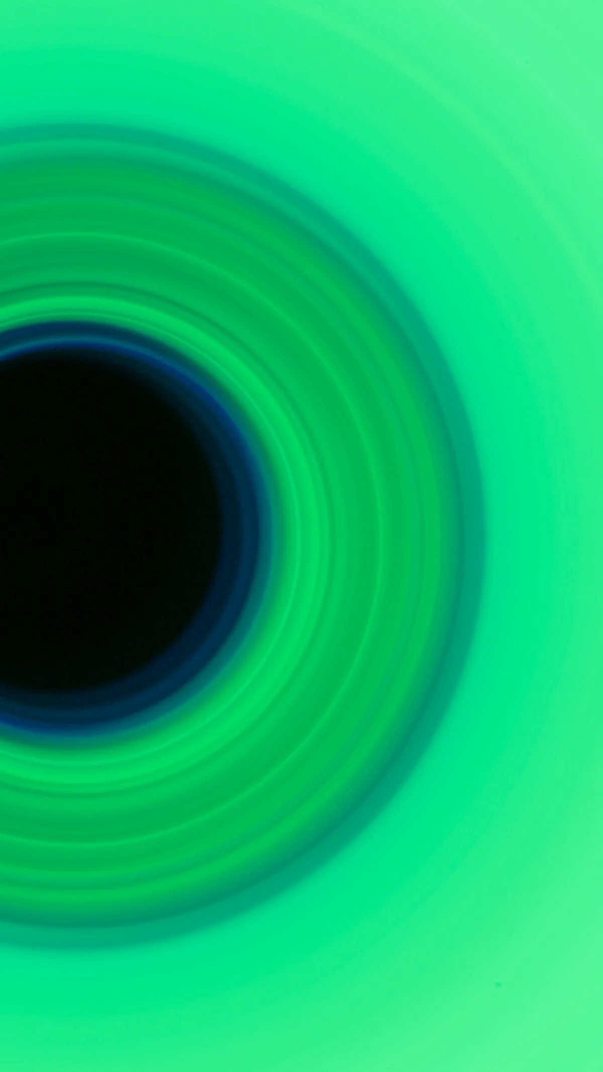 Green circular light artwork composed as a vertical creative