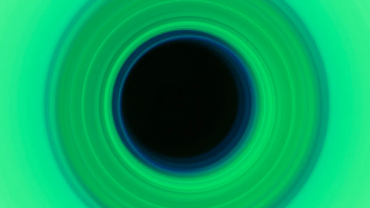 Green circular light artwork composed as a wide creative